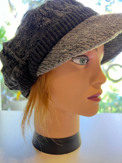 Mannequin wearing newsboy hat with hair attached in strawberry blonde human hair wig