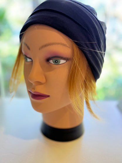 Mannequin wearing strawberry-blonde beanie with hair - human hair half wig 