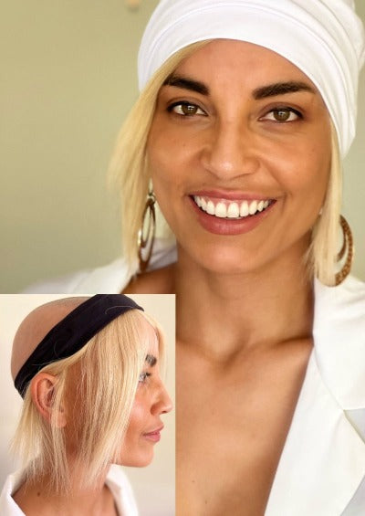 Creamy blonde human hair wig on black headband under white beanie and gold earings